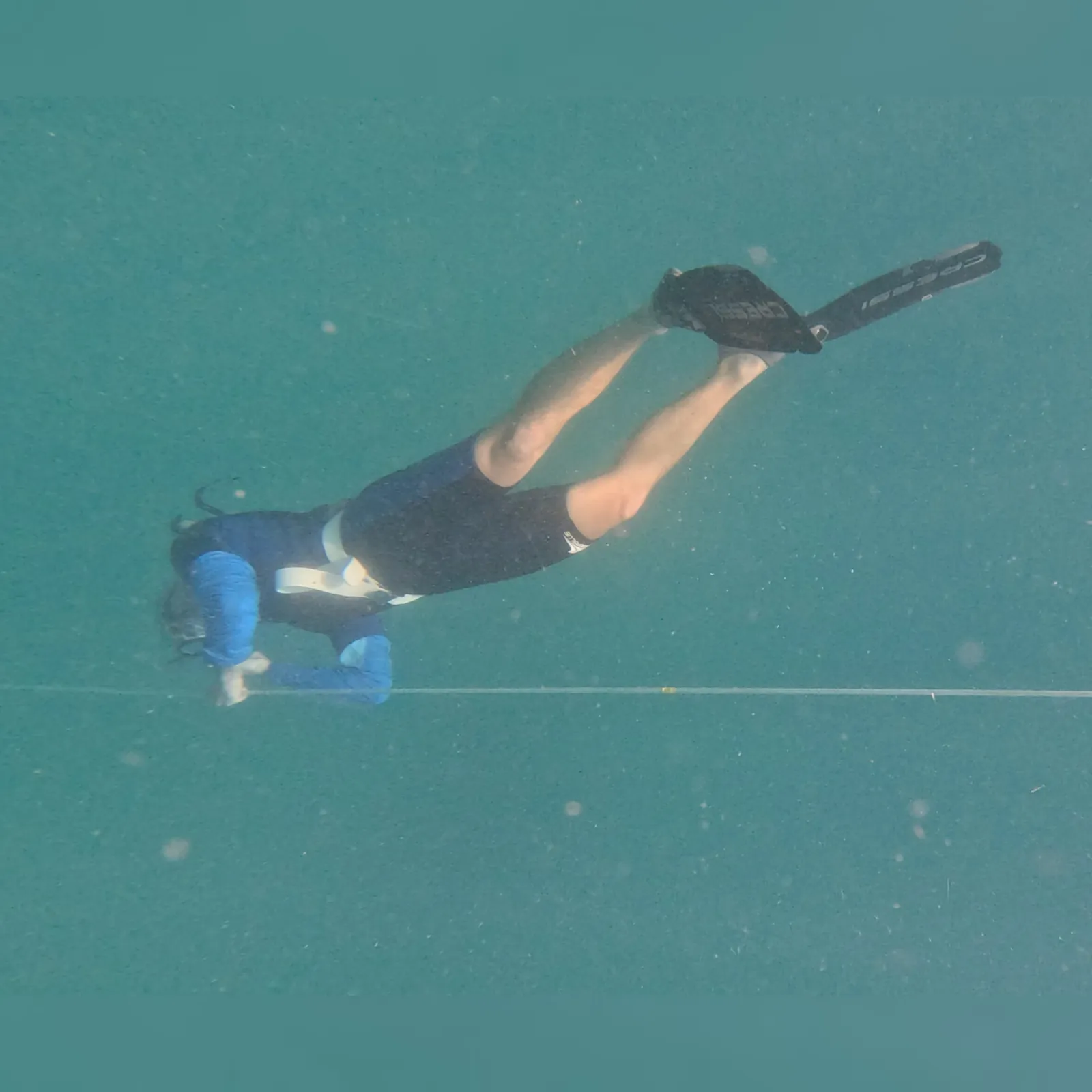 Freediver descending the line in constant weight with bifins